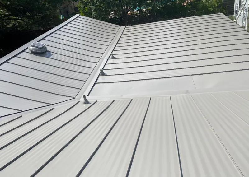 Solar attic fan installed on a metal roof for Roof Ventilation in Cedar Lake